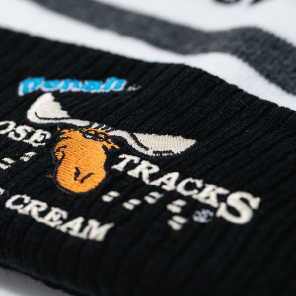 close up of winter beanie cuff. has embroidered moose tracks logo