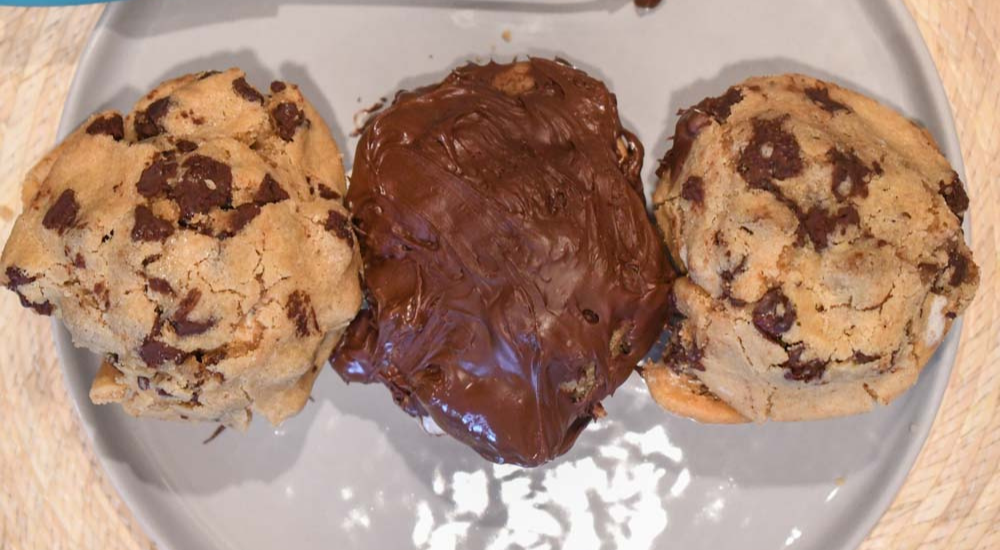 Moose tracks chocolate chip cookies with moose tracks ice cream inside. two cookies and one cookie with chocolate coating