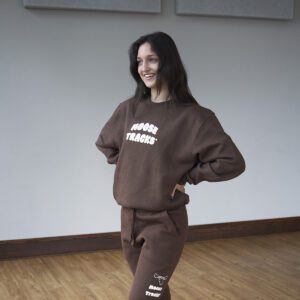 A brown crewneck sweatshirt with "Moose Tracks" in vanilla-colored screen printing