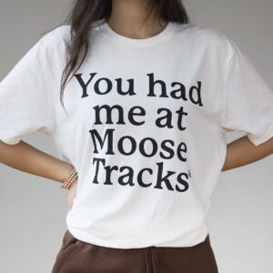 A vanilla-colored t-shirt with "You had me at Moose Tracks" in charcoal grey-colored screen printing