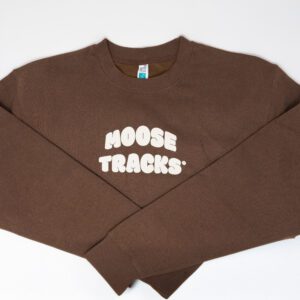 A brown crewneck sweatshirt with "Moose Tracks" in vanilla-colored screen printing