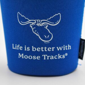 An up-close view of an ice cream pint with a Moose Tracks Ice Cream Koozie. The koozie is blue with a Moose Tracks logo and text reading "Life is Better with Moose Tracks" in white-colored screen printing.